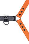 Orange leather bulldog harness with black hardware. Close up.