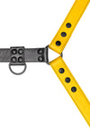 Yellow leather bulldog harness with black hardware. Close up.