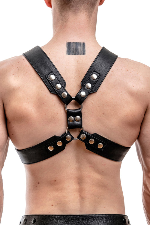 Model wearing a black leather commander harness with stainless steel hardware