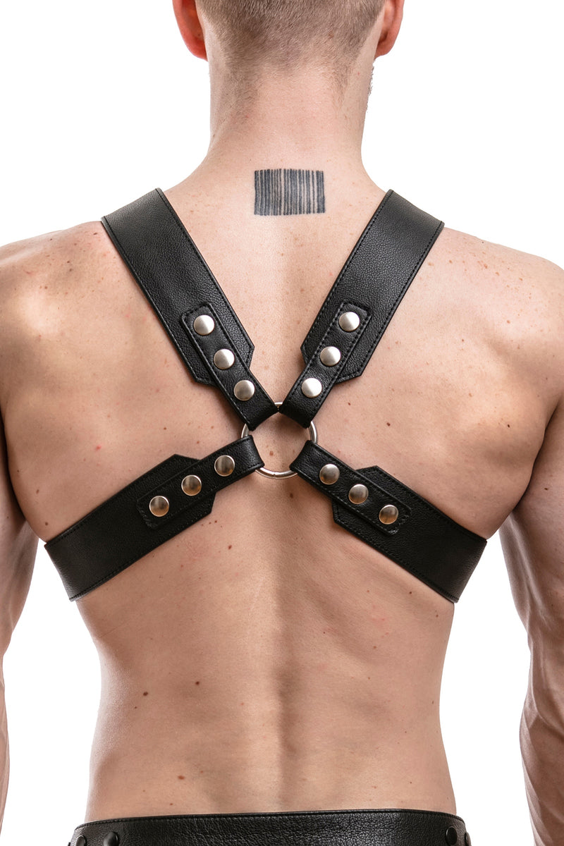 Model wearing a black leather sergeant x harness with stainless steel hardware