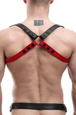 Model wearing red leather shoulder buckle harness back