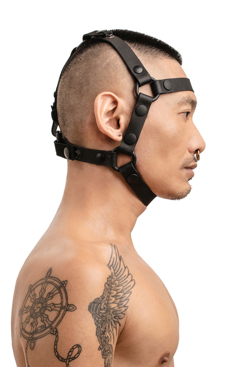 Model wearing black leather head harness side