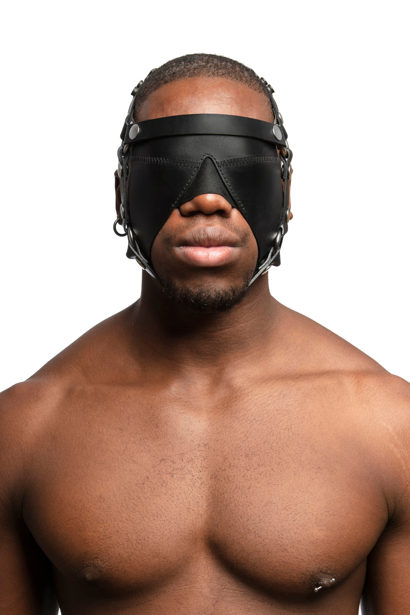 Model wearing black leather head harness and blinder with stainless steel hardware. Front view.