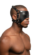 Model wearing black leather head harness and blinder with stainless steel hardware. Three quarter view.