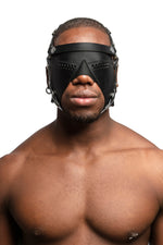 Model wearing black leather head harness and partial blinder with stainless steel hardware. Front view.