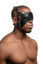 Model wearing black leather head harness and partial blinder with stainless steel hardware. Three quarter view.