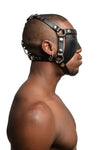 Model wearing black leather head harness and partial blinder with stainless steel hardware. Side view.