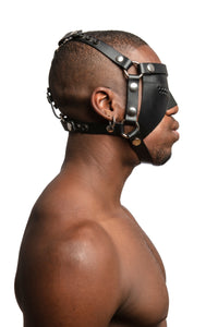 Model wearing black leather head harness and partial blinder with stainless steel hardware. Side view.