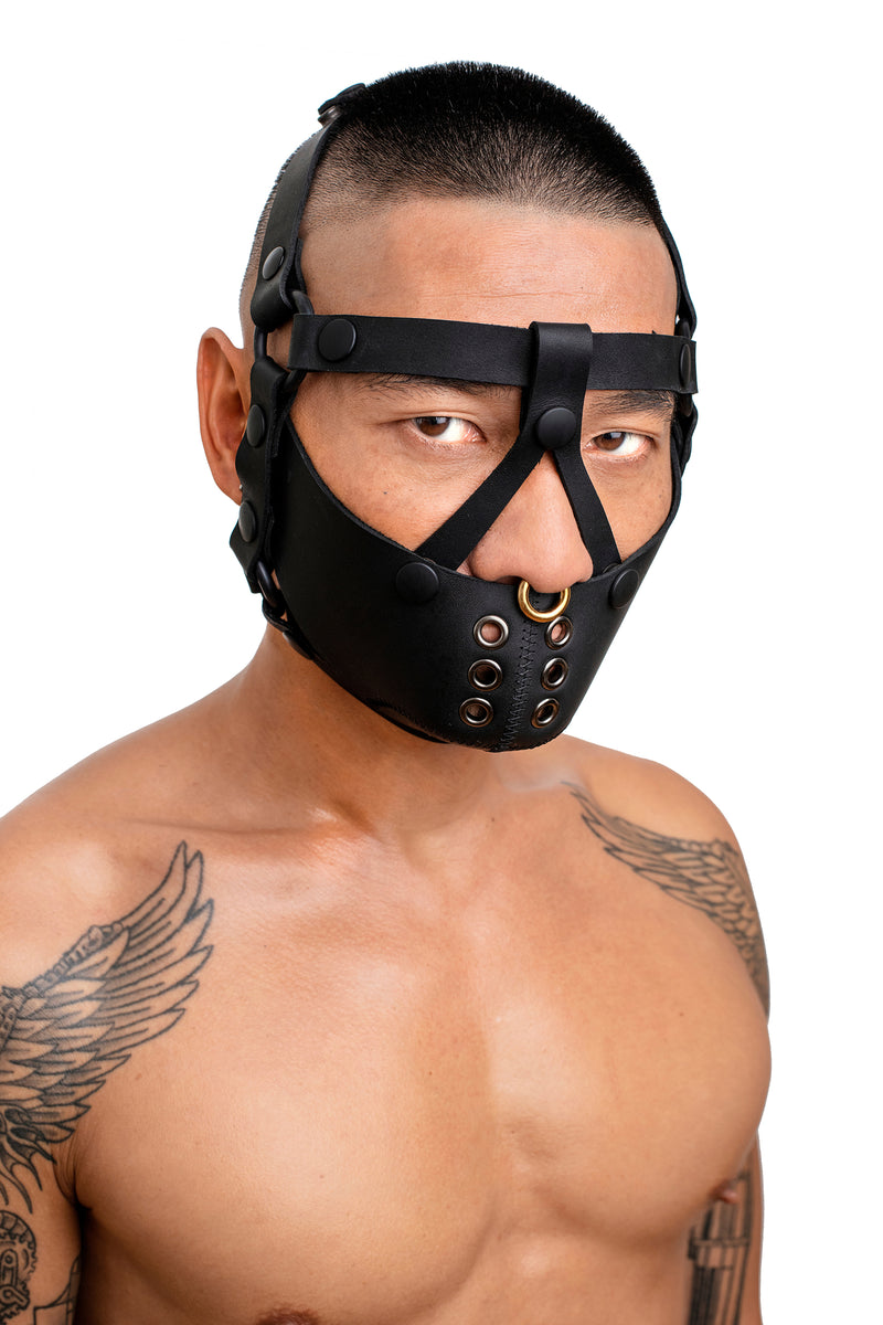 Model wearing black leather head harness and muzzle front