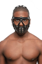 Model wearing black leather head harness and muzzle with stainless steel hardware, front