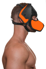 Model wearing a black and fluro orange leather pup mask and head harness side view