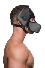 Model wearing a black and grey leather pup mask and head harness side view