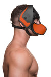 Model wearing a black and orange leather pup mask and head harness side view