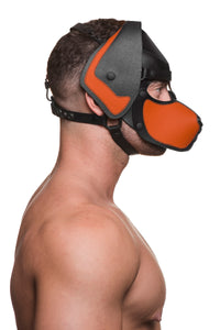 Model wearing a black and orange leather pup mask and head harness side view