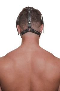 Model wearing a black leather pup mask and head harness with stainless steel hardware back view