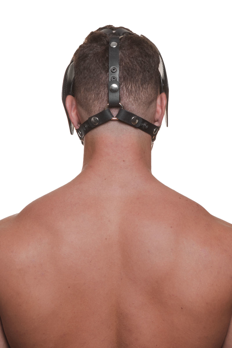 Model wearing a black leather pup mask and head harness with stainless steel hardware back view