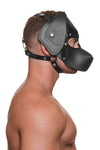 Model wearing a black leather pup mask and head harness with stainless steel hardware side view