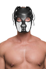 Model wearing a black and white leather pup mask and head harness with stainless steel hardware front view