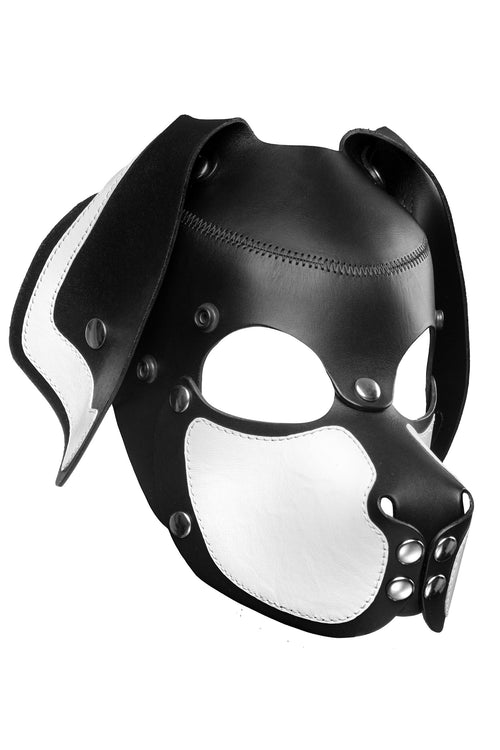 Product photo of a black and white leather pup mask with floppy ears and stainless steel hardware three quarter view