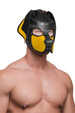Model wearing a black and yellow leather pup mask and head harness three quarter view