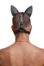Model wearing a black leather pup mask and head harness back view