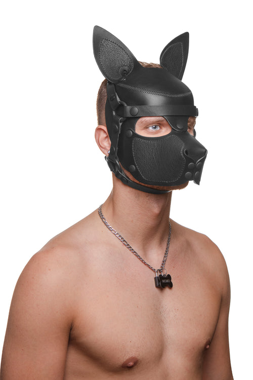Model wearing a black leather pup mask and head harness three quarter view