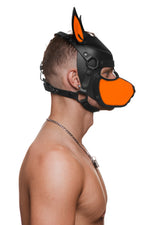 Model wearing a black and fluro orange leather pup mask and head harness side view