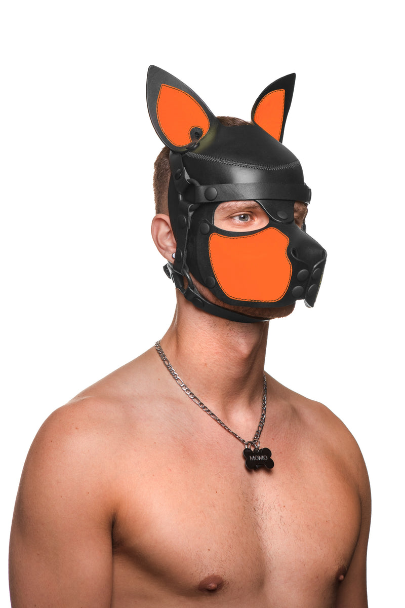 Model wearing a black and fluro orange leather pup mask and head harness three quarter view