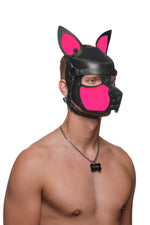 Model wearing a black and fluro pink leather pup mask and head harness three quarter view