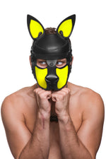 Model wearing a black and fluro yellow leather pup mask and head harness front view