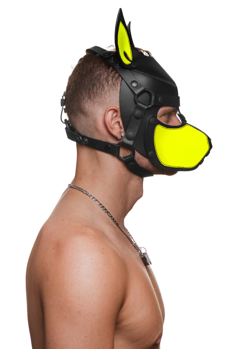 Model wearing a black and fluro yellow leather pup mask and head harness side view