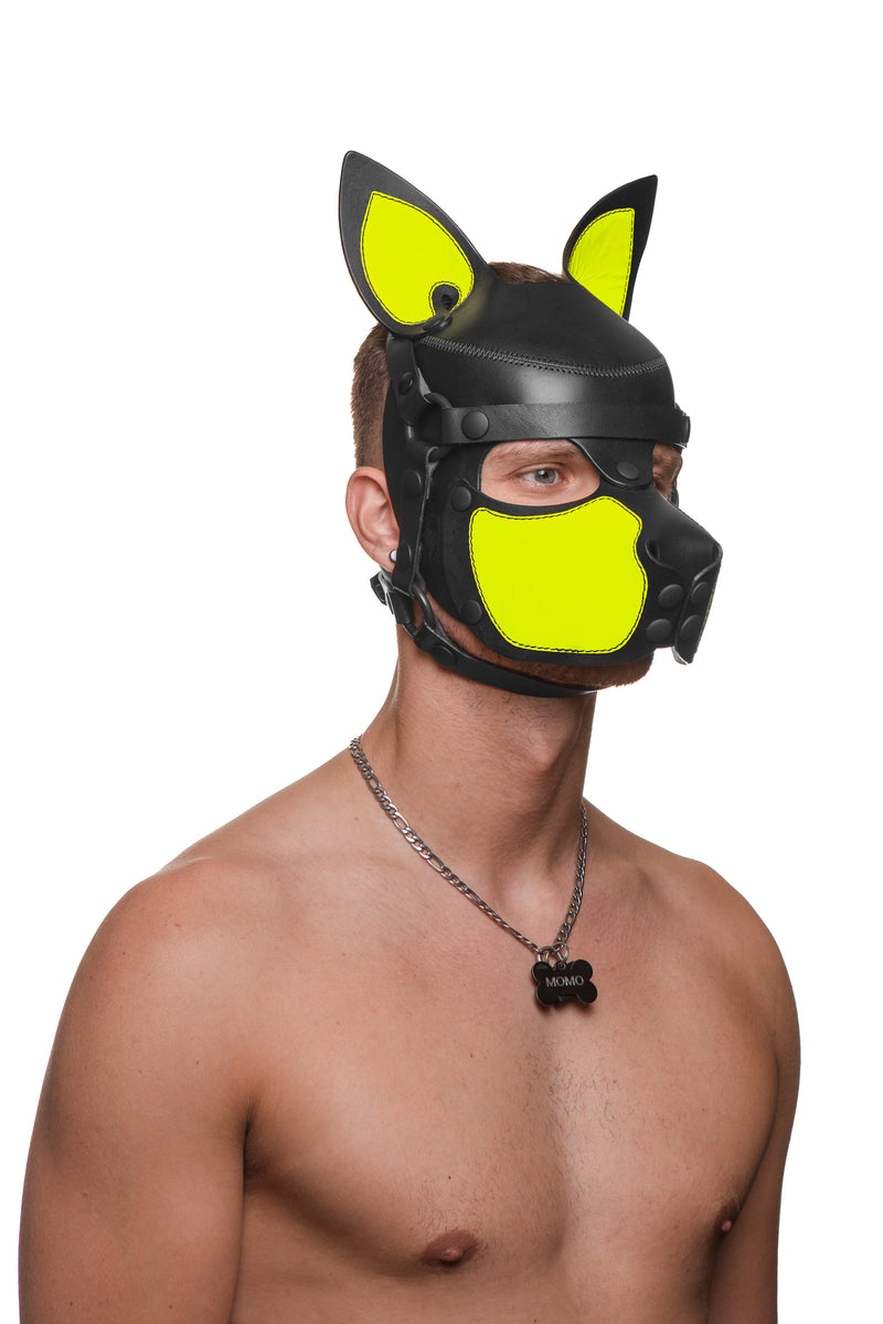Model wearing a black and fluro yellow leather pup mask and head harness three quarter view