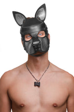 Model wearing a black and metallic silver leather pup mask and head harness front view