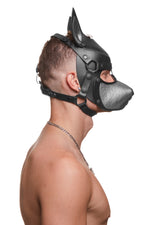 Model wearing a black and metallic silver leather pup mask and head harness side view