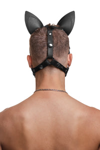 Model wearing a black leather pup mask and head harness with stainless steel hardware back view