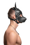 Model wearing a black leather pup mask and head harness with stainless steel hardware side view