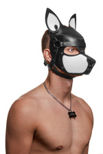 Model wearing a black and white leather pup mask and head harness three quarter view