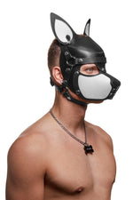 Model wearing a black and white leather pup mask and head harness with stainless steel hardware three quarter view