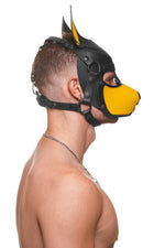 Model wearing a black and yellow leather pup mask and head harness side view