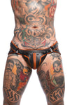 Model wearing a black and orange combat leather jockstrap. Front view.
