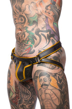 Model wearing a black and yellow combat leather jockstrap. Side view.