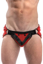 Model wearing a red leather jockstrap with red and black leather chevron codpiece. Front view.