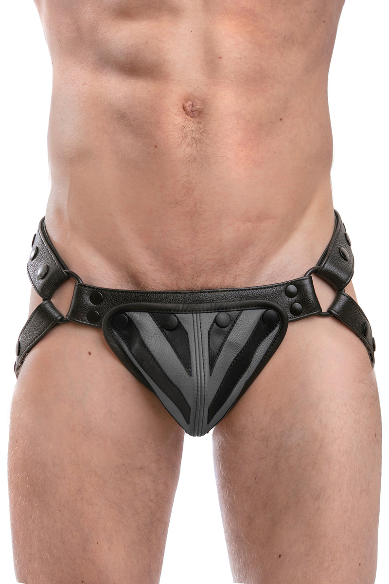 Model wearing a black leather jockstrap with grey and black leather tiger striped codpiece