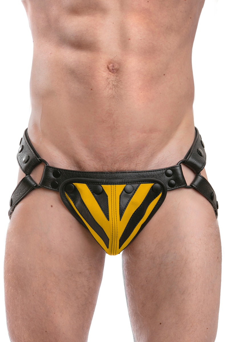 Model wearing a black leather jockstrap with yellow and black leather tiger striped codpiece