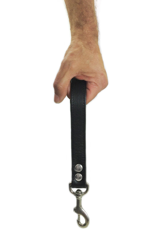 Model holding black leather and stainless steel handle leash