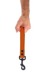 Model holding orange leather handle leash