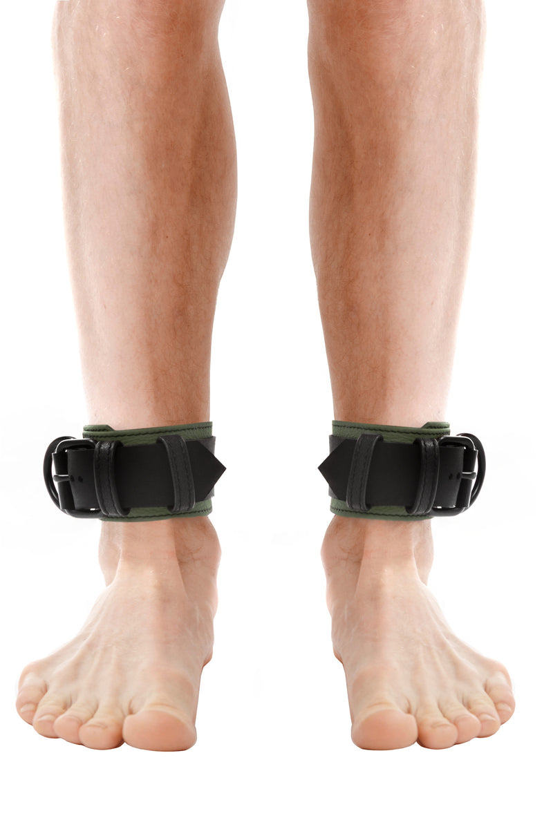 Model wearing army green and black leather ankle restraints
