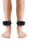 Model wearing blue and black leather ankle restraints