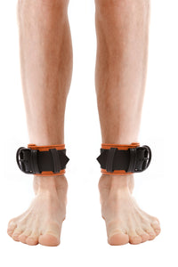 Model wearing orange and black leather ankle restraints