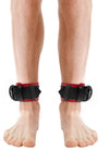 Model wearing red and black leather ankle restraints